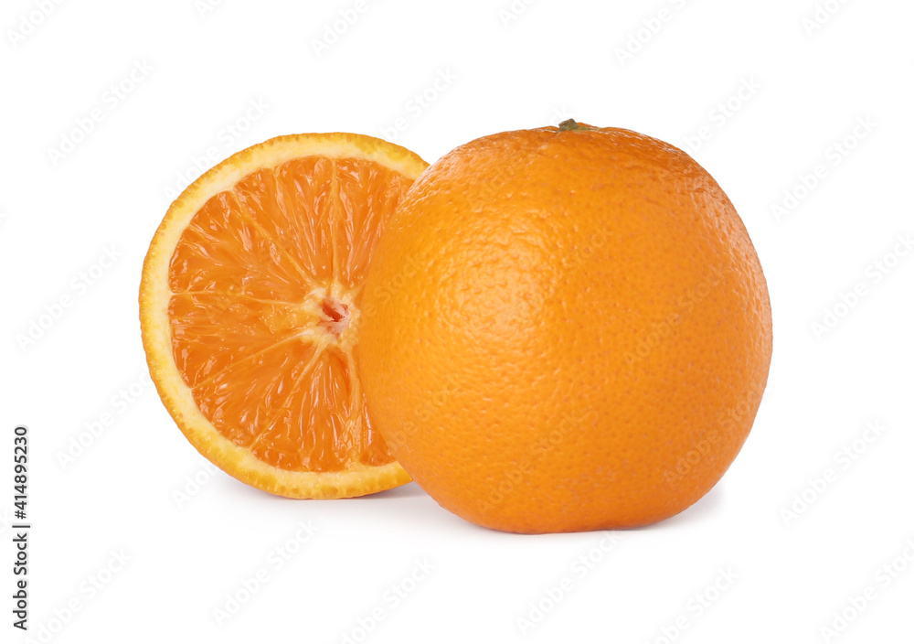 Cut and whole ripe oranges on white background