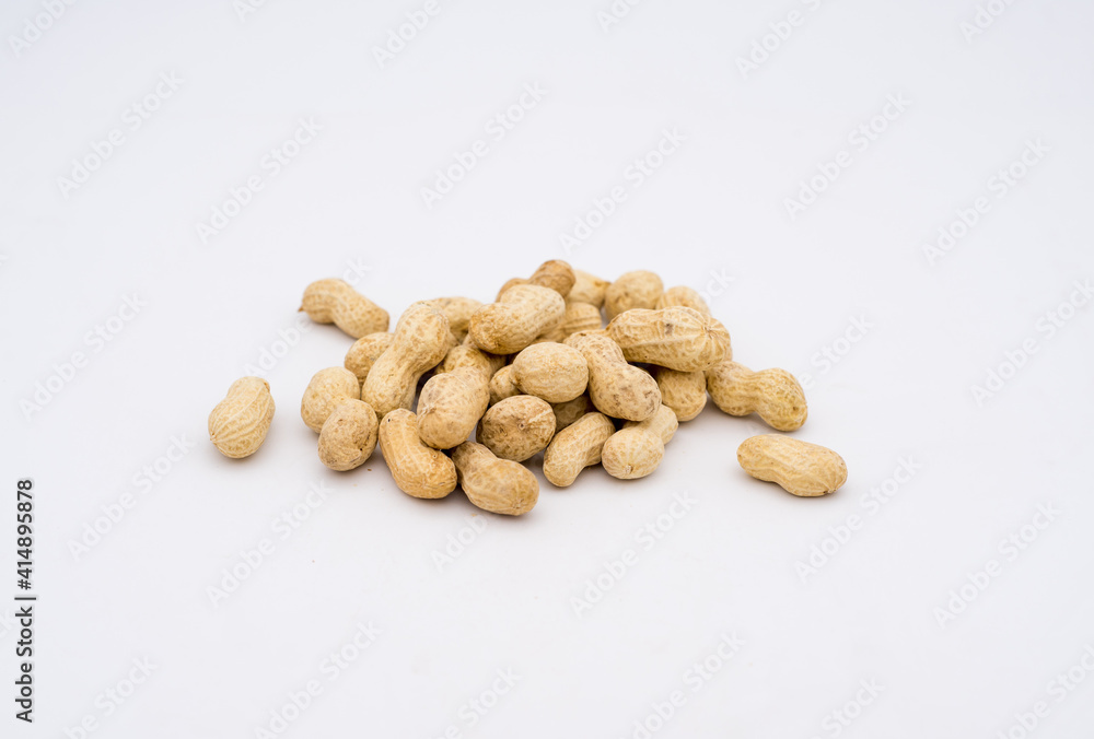 A pile of peanuts on a white background A pile of peanuts on a white background