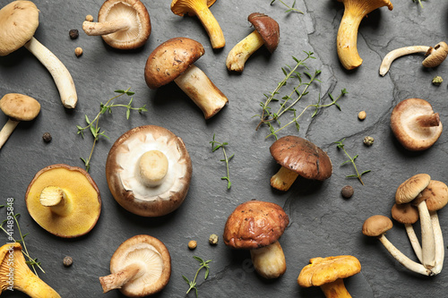 Flat lay composition with fresh mushrooms, thyme and pepper on grey background