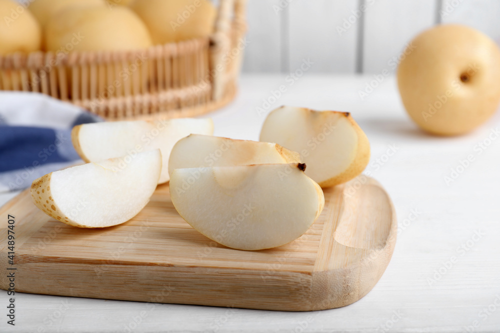 Slices of apple pear on white wooden table Slices of apple pear on white wooden table