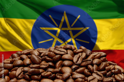 Roasted coffee beans on the background of the flag of Ethiopia. Concept: best flavored coffee, export and import.