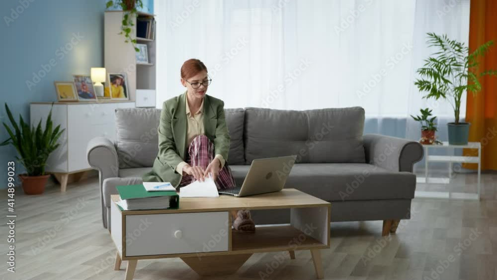 online conference, young woman wearing glasses for vision of jacket and pajamas talking using digital technologies via video communication on laptop during office work at home online conference, young woman wearing glasses for vision of jacket and pajamas talking using digital technologies via video communication on laptop during office work at home