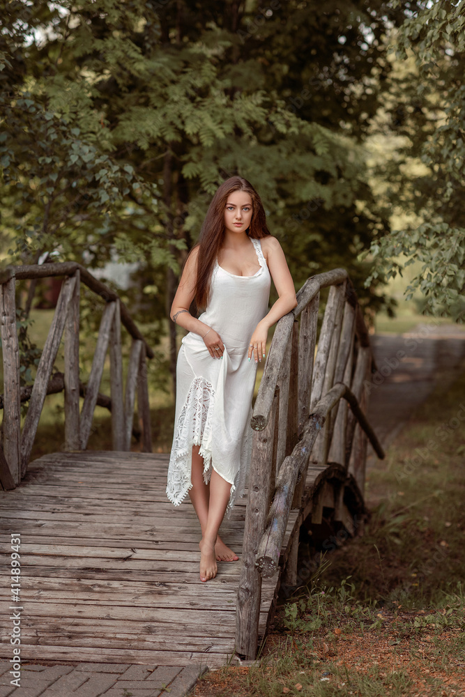 beautiful girl in the summer park standing on bridge
beautiful girl in the summer park standing on bridge