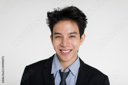 Young and handsome healthy Asian woman with a friendly smiley face and positive happy pose on a plain background. Concept for joy, proud, self-confident, and successful male in business and life