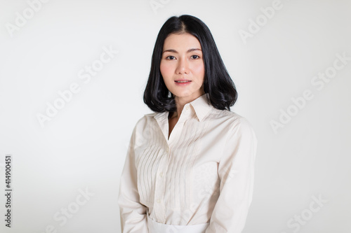 Young and beautiful healthy Asian woman with a friendly smiley face and positive happy pose on a plain background. Concept for joy, proud, self-confident, and successful female in business and life