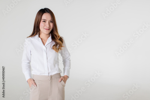 Young and beautiful healthy Asian woman with a friendly smiley face and positive happy pose on a plain background. Concept for joy, proud, self-confident, and successful female in business and life