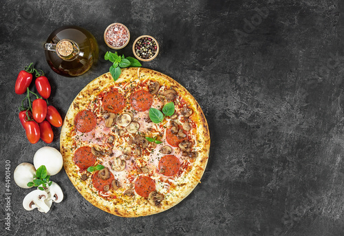 Hot italian Napoli pizza with ham and mushrooms on dark background