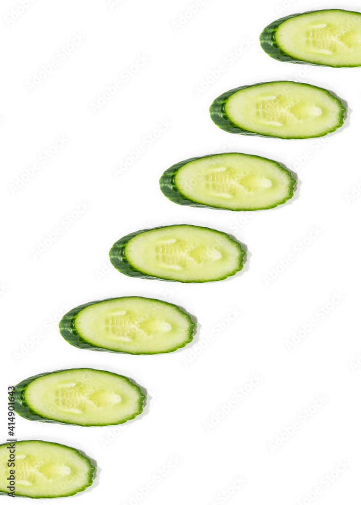 Cucumbers pattern of fresh vegetables sliced
on a white background Cucumbers pattern of fresh vegetables sliced
on a white background