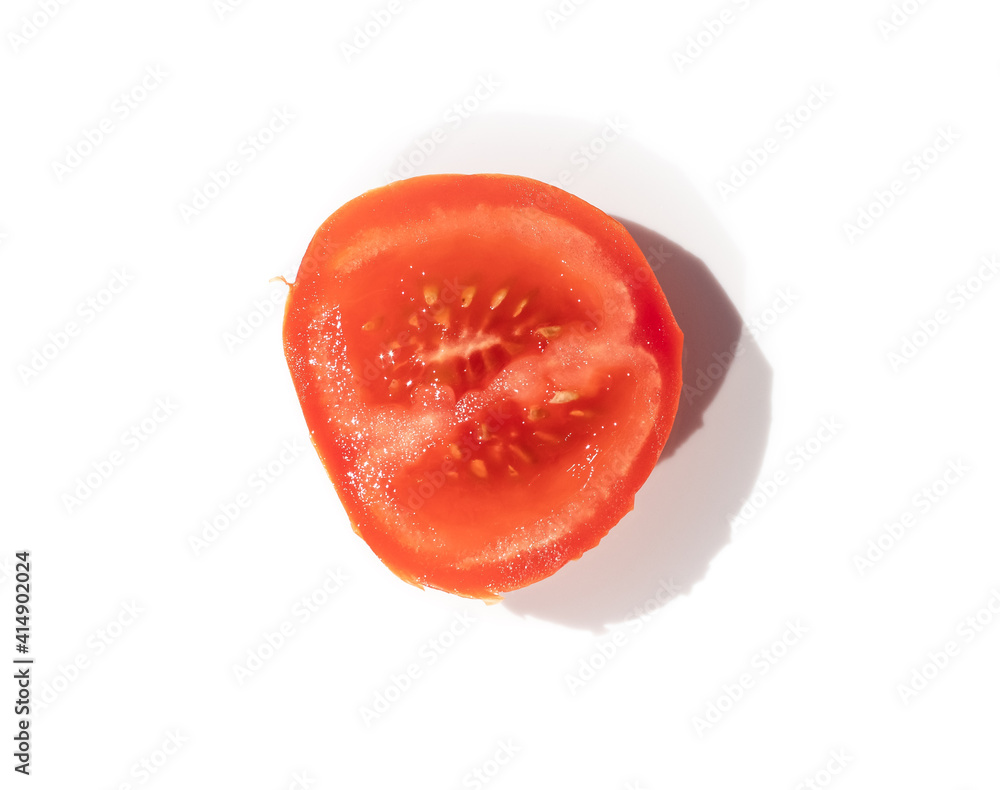 one sliced tomato on a white background one sliced tomato on a white background