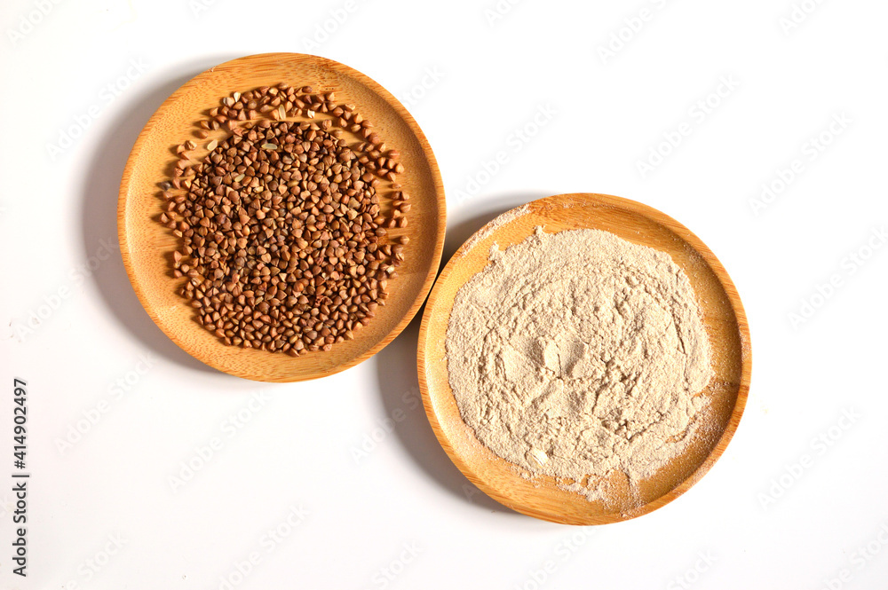Buckwheat groats and buckwheat flour on a white background Buckwheat groats and buckwheat flour on a white background