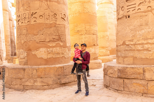 father and his son visit Luxor temple in Luxor, Egypt (ancient Thebes).  photo