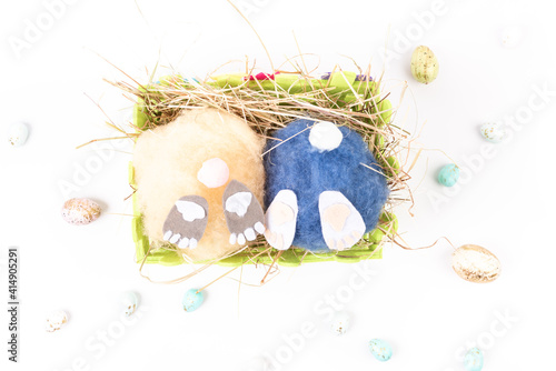 two handmade fluffy easter bunnys and colorful eggs