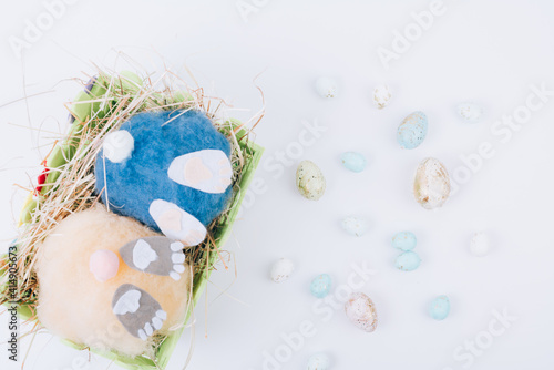 two handmade fluffy easter bunnys and colorful eggs