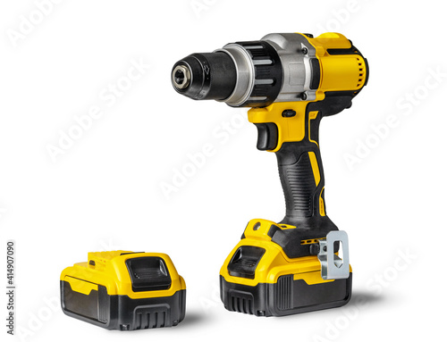 Yellow-black cordless Combi Drill Driver Hammer Drill and extra battery isolated on white background.