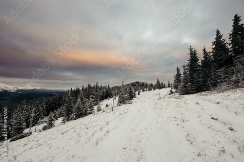 A man riding on top of a snow covered slope