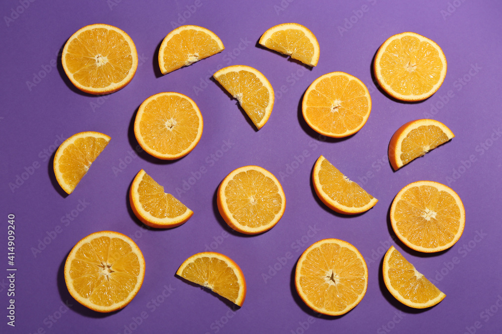 Flat lay composition with fresh ripe oranges on purple background Flat lay composition with fresh ripe oranges on purple background