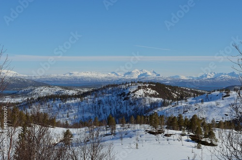 Deep snow covered mountain range on a sunny day in Northern Norway. © Arcticphotoworks