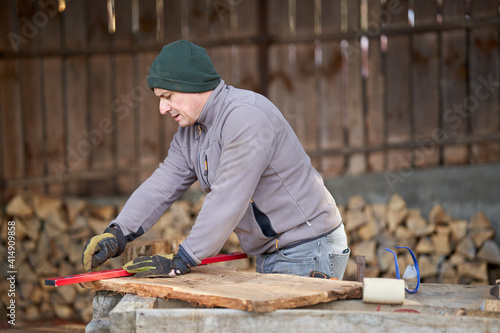 Carpenter measuring and drawing walnut wood