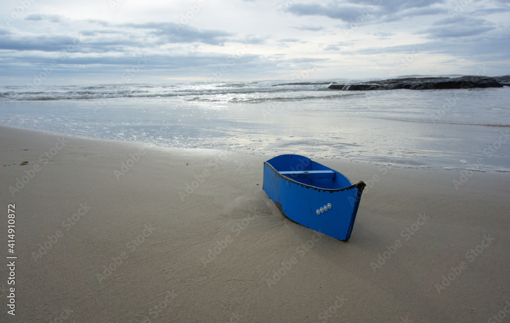 Beautiful sho of a boat on the beach under a cloudy sky in Brazil Beautiful sho of a boat on the beach under a cloudy sky in Brazil
