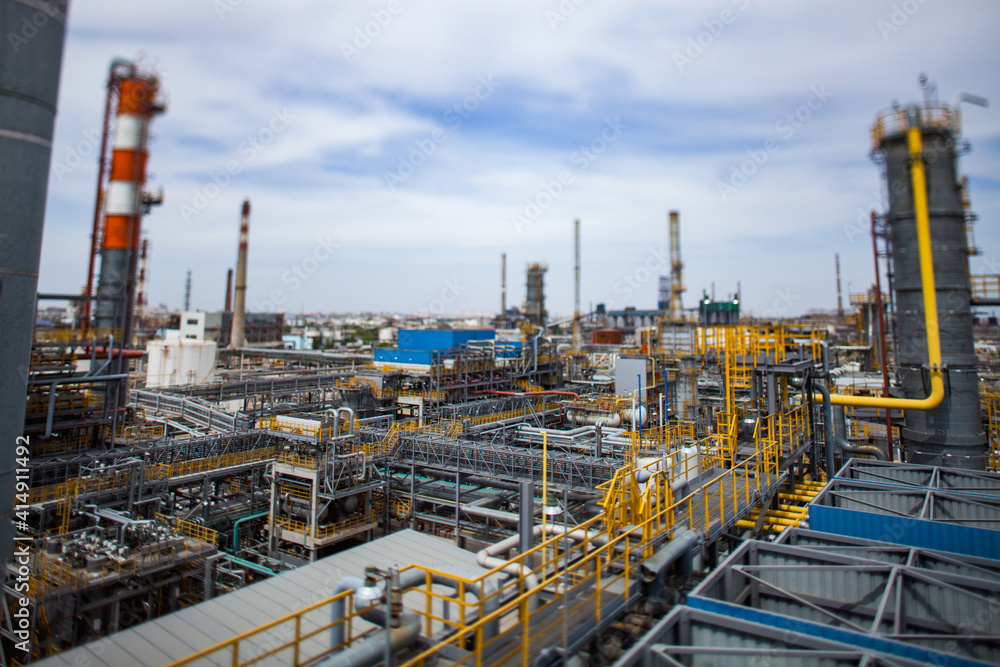 Panorama view of crude oil refinery complex in desert. Oil refinery plant. Tilt-shift photo, partially blurred Panorama view of crude oil refinery complex in desert. Oil refinery plant. Tilt-shift photo, partially blurred