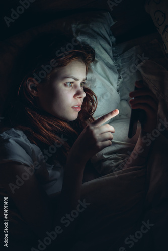 woman with a phone in her hands at night before bedtime emotions addiction communication