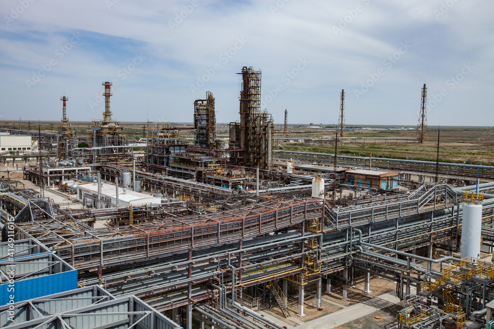 Panorama view of oil refinery plant. the distillation columns and pipelines. And gas torch masts.