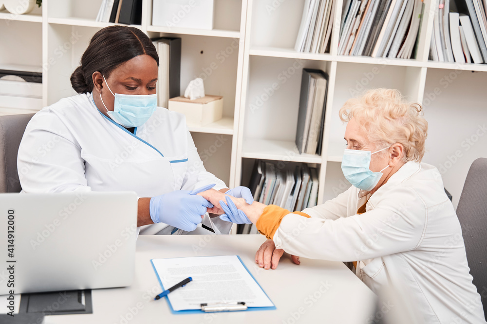 Physician consulting old female patient Physician consulting old female patient