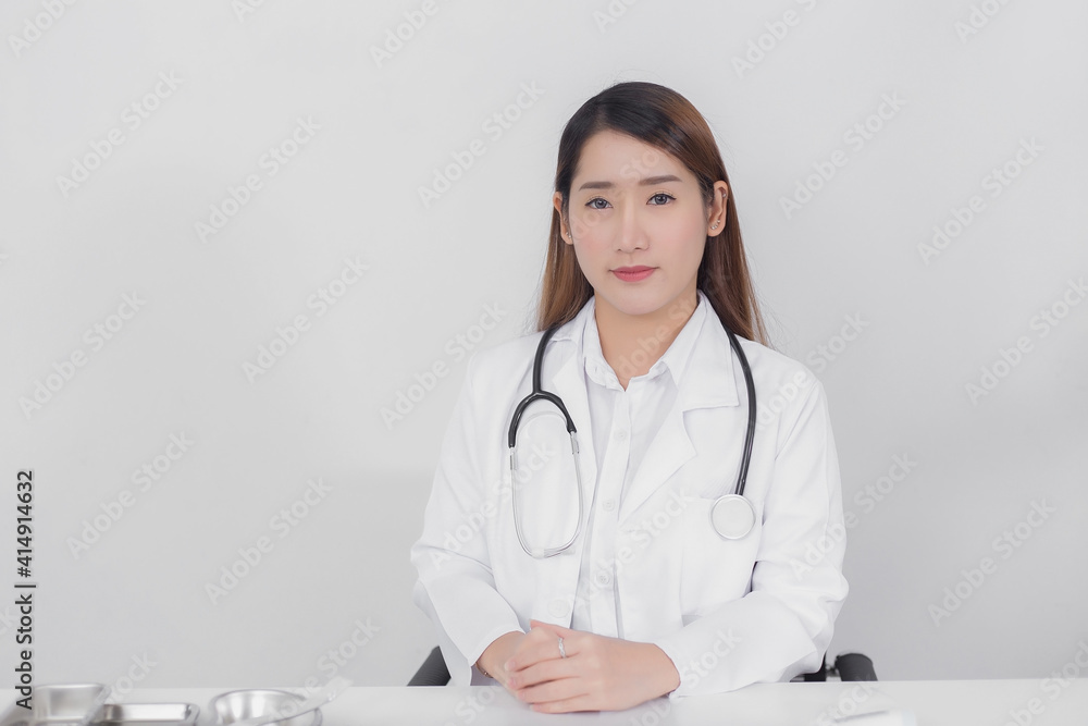 Asian female doctor looking straight at the hospital wearing a white coat and a stethoscope On a white background Health care concept. Asian female doctor looking straight at the hospital wearing a white coat and a stethoscope On a white background Health care concept.