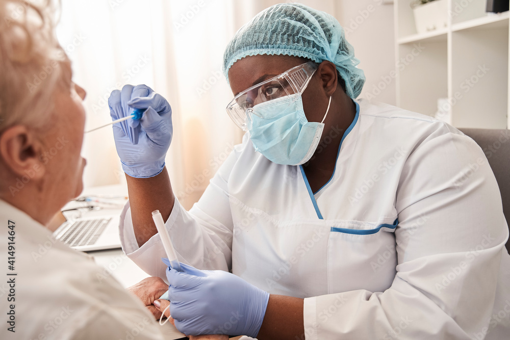 Fototapeta premium Nurse taking a sample from potentially infected woman