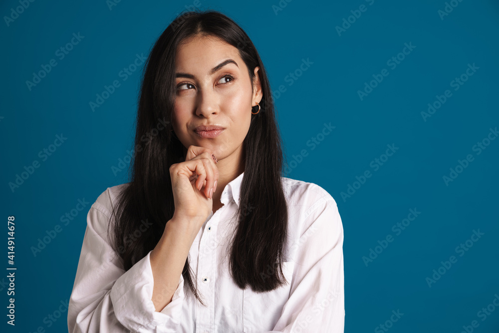 Puzzled beautiful asian girl thinking and looking aside Puzzled beautiful asian girl thinking and looking aside