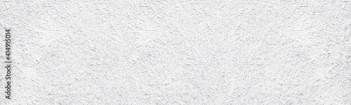 Whitewashed old rough concrete wall wide texture. White painted textured cement plaster panoramic abstract background