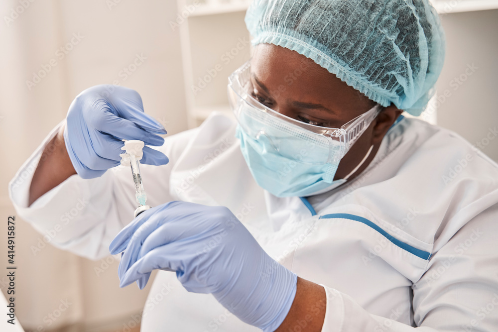 Doctor working with syringe needle and ampoule Doctor working with syringe needle and ampoule