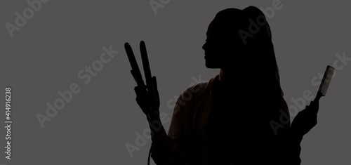 Hairstylist silhouette with an iron and a flat comb