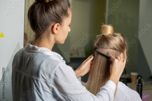 Hairstylist making styling in a beauty salon