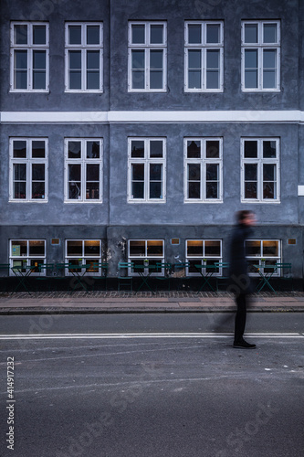 Some people are walking in front of a building in Copenhagen  Denmark  Nord Europe
