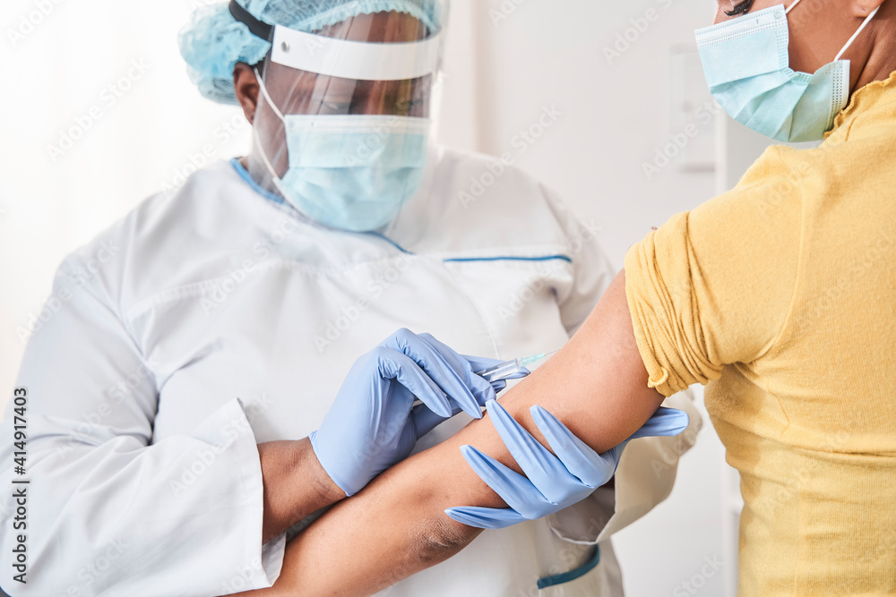 Caucasian girl receiving vaccine while standing in hospital Caucasian girl receiving vaccine while standing in hospital