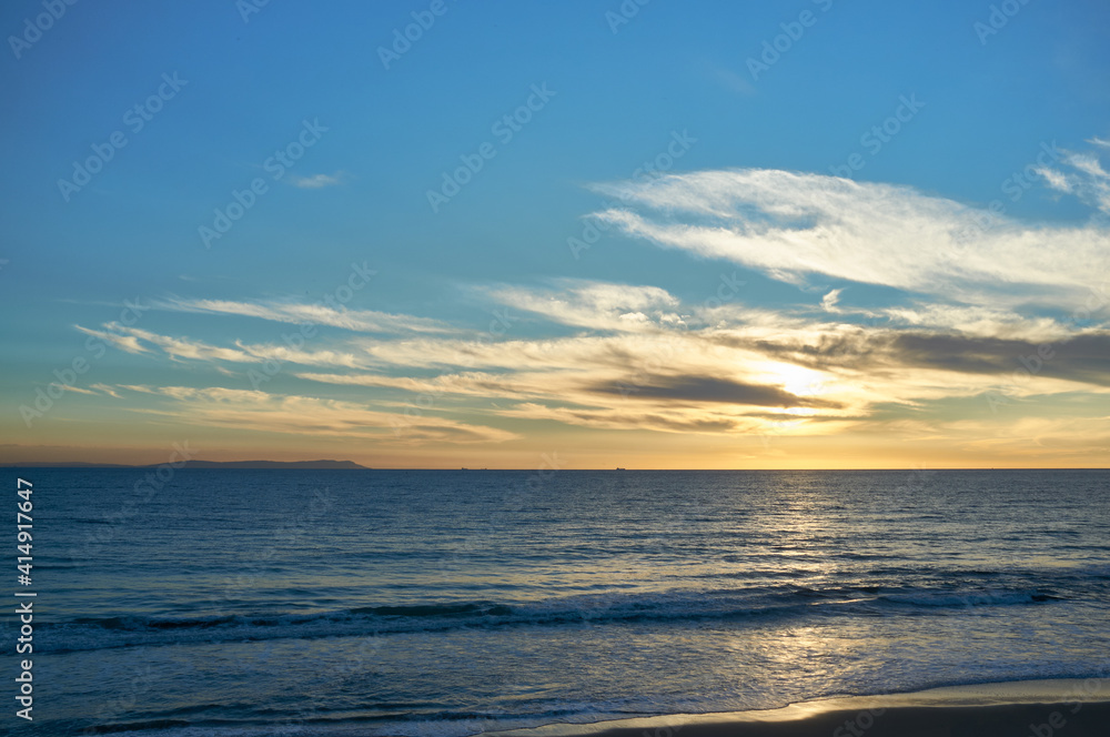 Sunset sky and ocean nature background. Atlantic ocean sunset, Tarifa, Cadiz, Andalusia, Spain