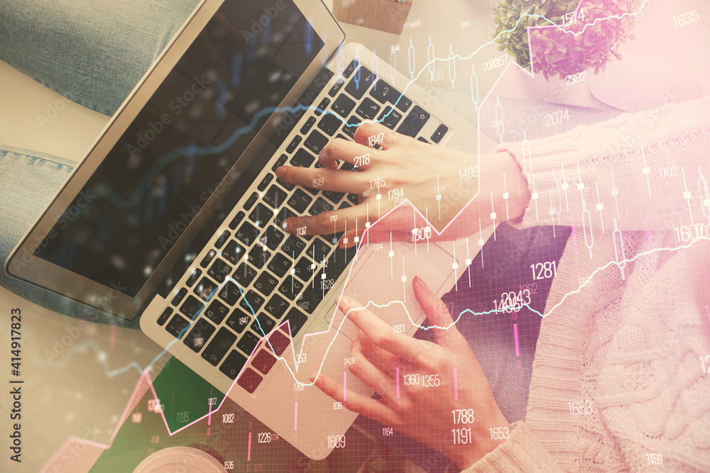 Double exposure of woman hands working on computer and forex chart hologram drawing. Top View. Financial analysis concept. Double exposure of woman hands working on computer and forex chart hologram drawing. Top View. Financial analysis concept.
