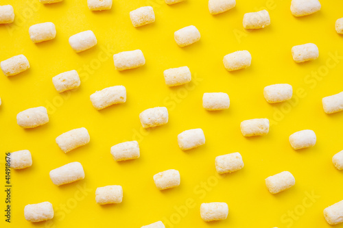 Background of air corn sticks pattern texture on yellow background