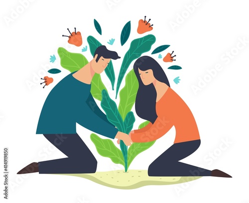 Man and woman planing seedling of flower or tree