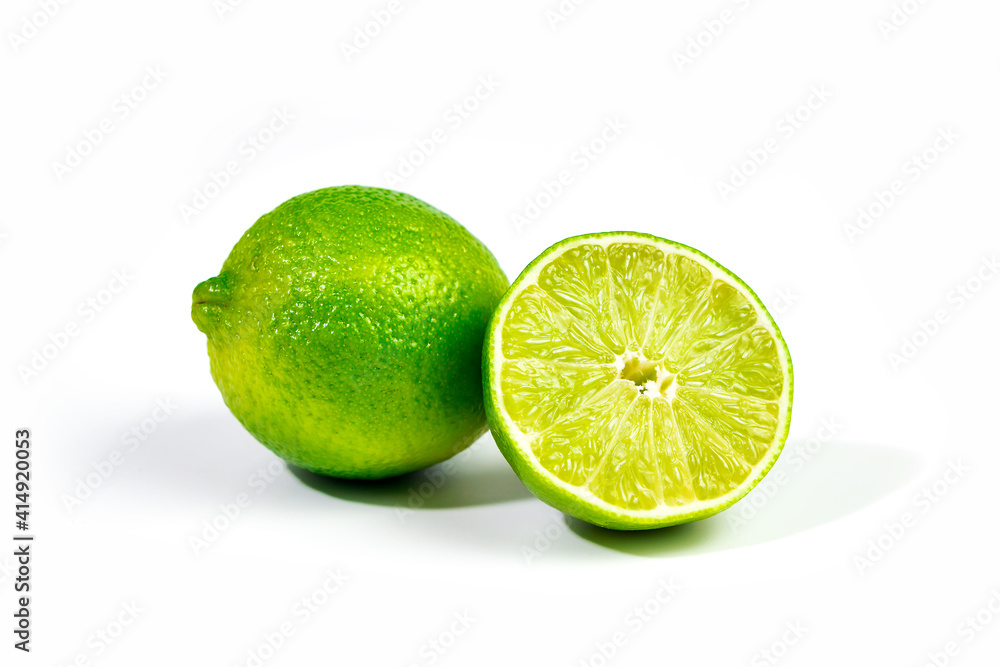 Whole lime and halfe of lime fruit close up with selective focus, isolated on white background with clipping path Whole lime and halfe of lime fruit close up with selective focus, isolated on white background with clipping path