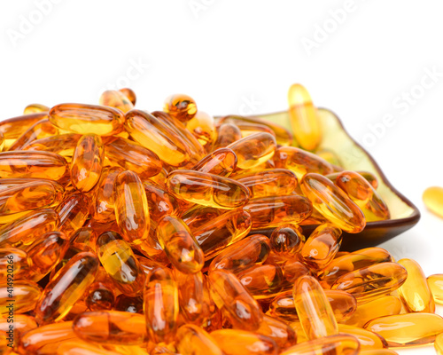 Vitamin Omega-3 fish oil capsules on white background photo