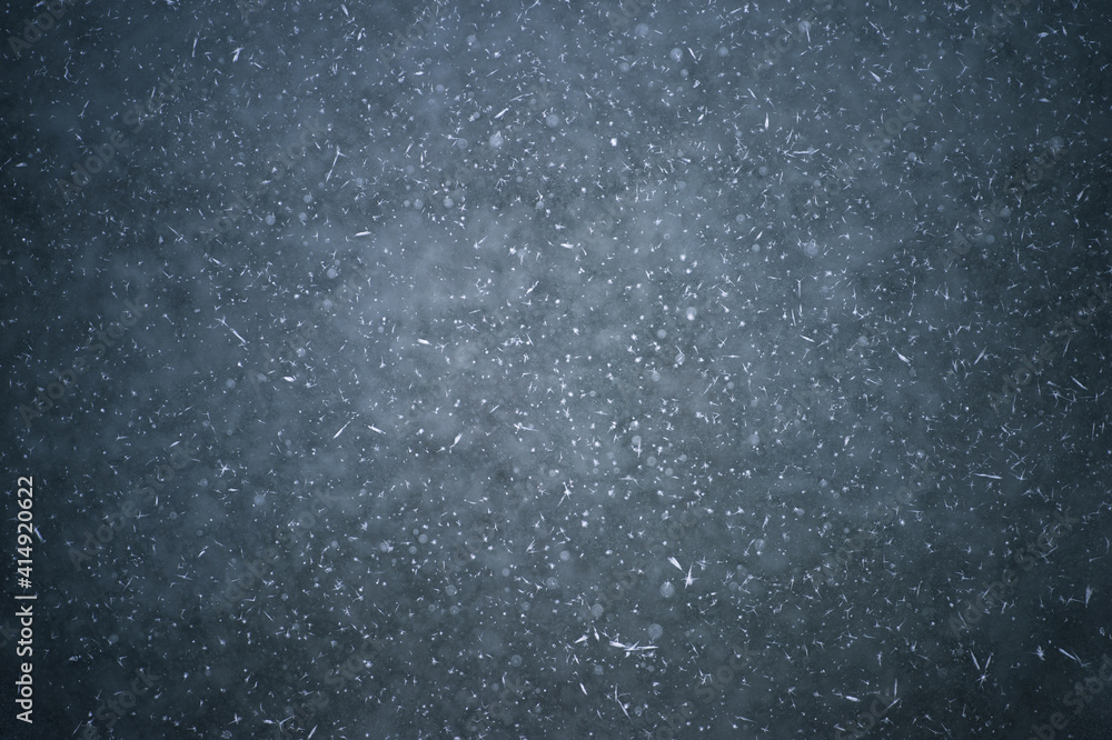 White crystals of frost on the ice with frozen bubbles of water. Background