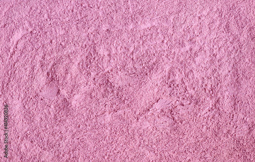 Rose cosmetic clay powder (alginate facial mask, body wrap, make-up blusher) texture close up, selective focus. Abstract pale pink background.