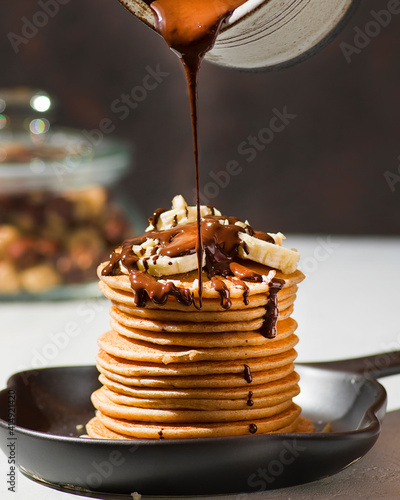 pancakes with banana, chocolate and hazelnuts photo