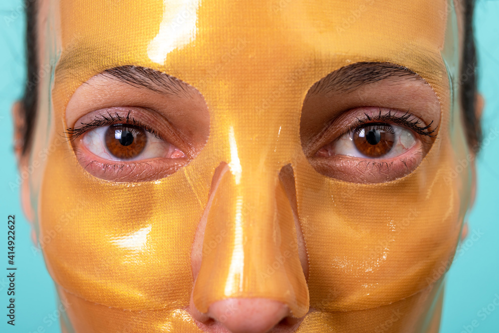 Fototapeta premium Beautiful woman using facial collagen gel skincare mask treatment