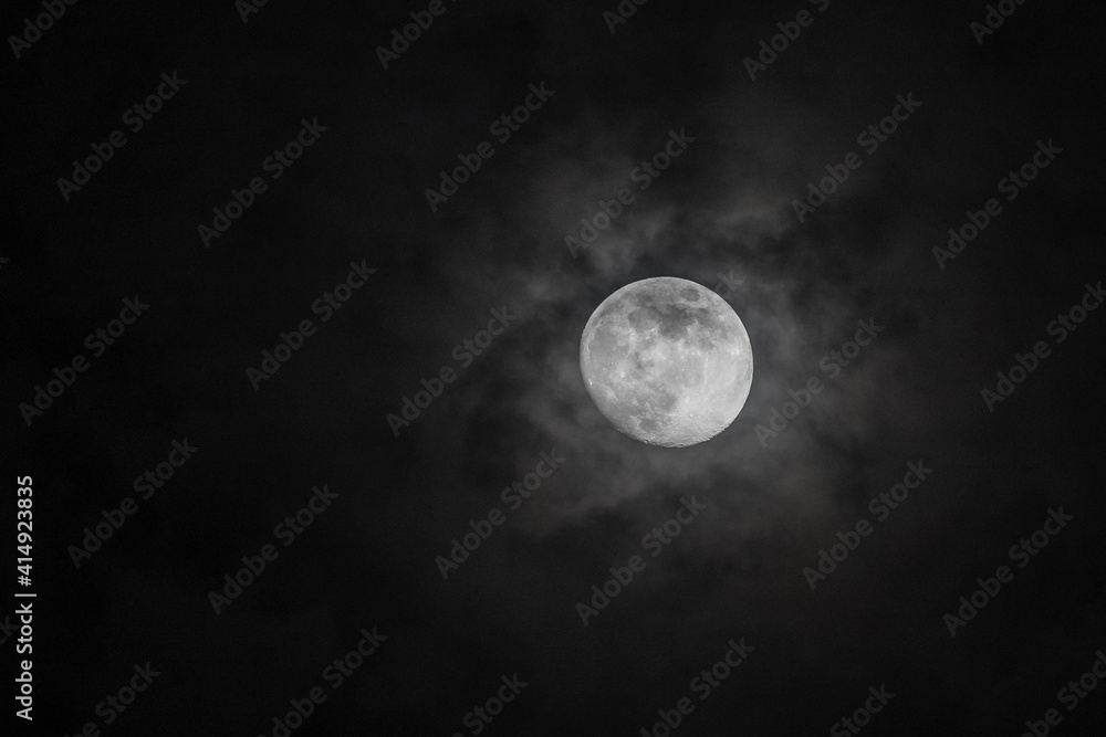 Halloween full moon in pitch black dark skies with clouds Halloween full moon in pitch black dark skies with clouds