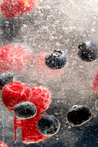 Raspberry and blueberry in carbonated water
