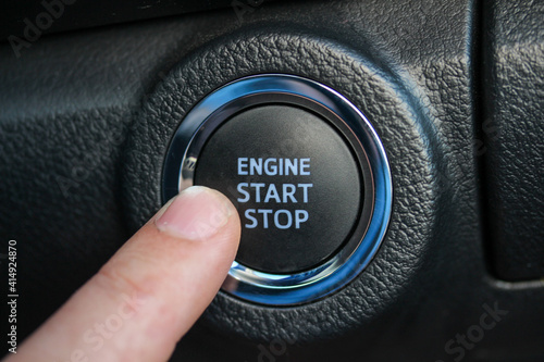 Finger pushing engine start stop button © hanjosan