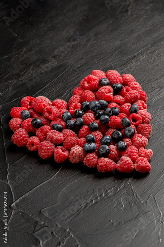 Raspberry and blueberry in heart shape